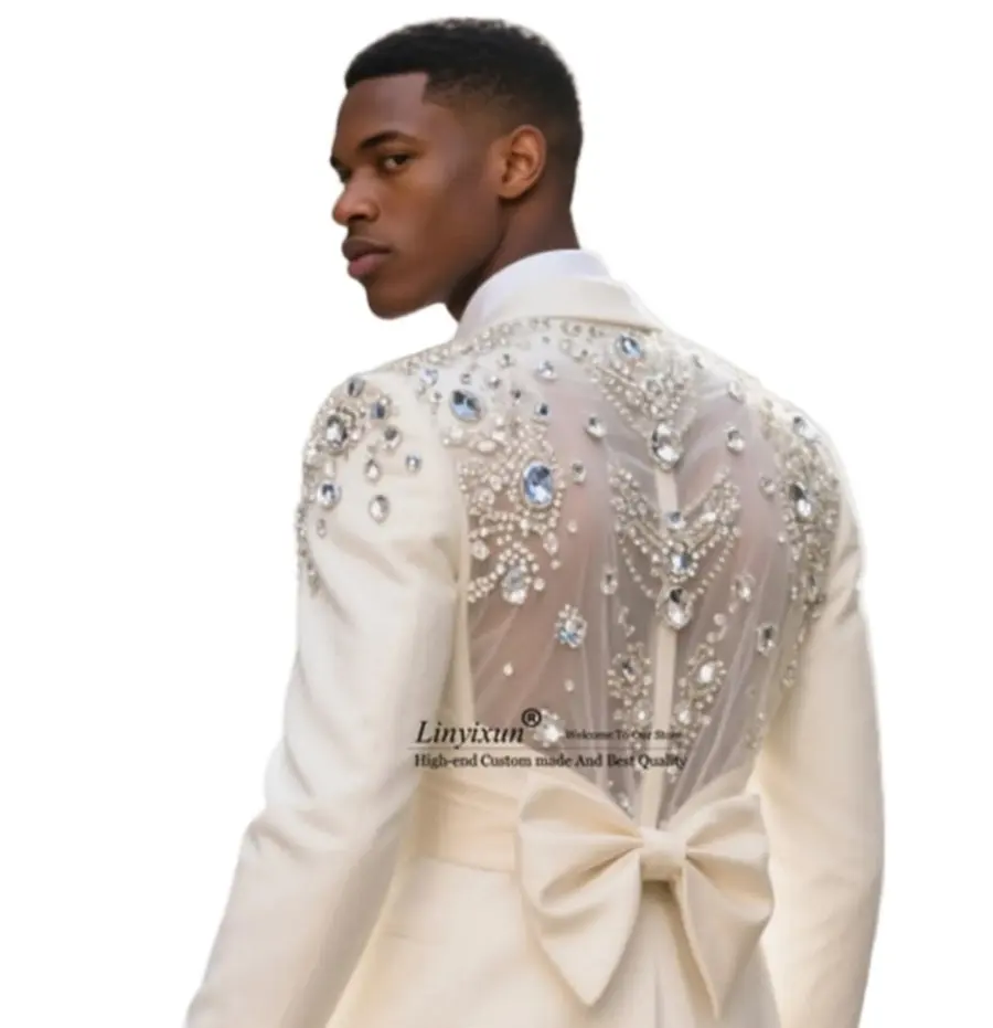 An ivory jacket with a crystal beaded sheer back panel and a bow at the waist
