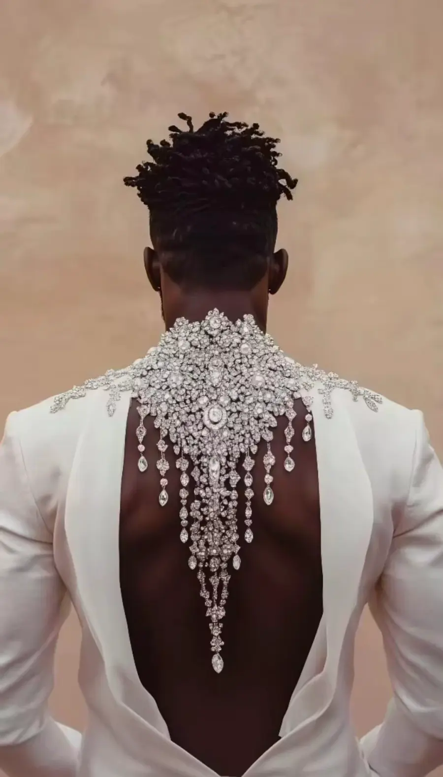An open backed ivory look with a crystal embellished neckpiece